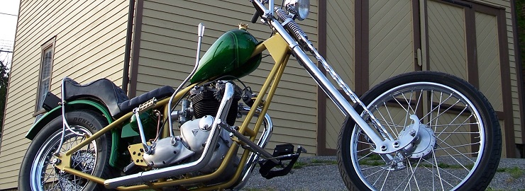 "Gallows", a custom Triumph chopper built by DeVille Cycles. Features a hardtail frame, hand shift and 60s style twisted springer front end.