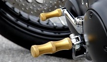 DeVille Cycles solid brass HourGlass footpegs and toe peg installed on an EVO Harley Sportster.
