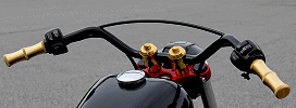 Retro style bobber handlebars feature a cross bar for a distinctive look.