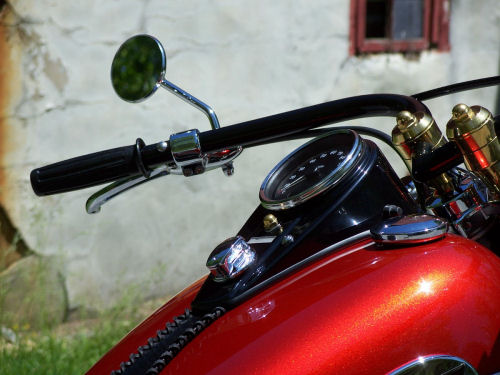 DeVille Cycles brass risers, vintage beach bar handlebars, leather tank panel and early style dash.