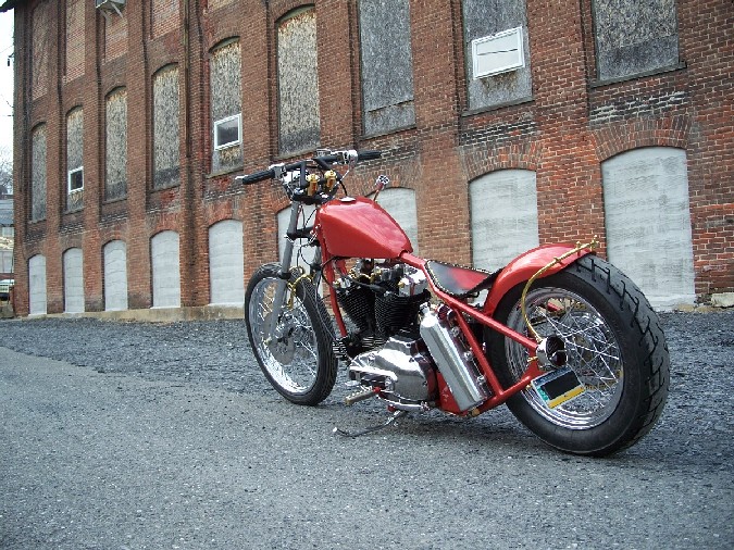 Custom aluminum oil tank and solid brass fork brace by DeVille Cycles.